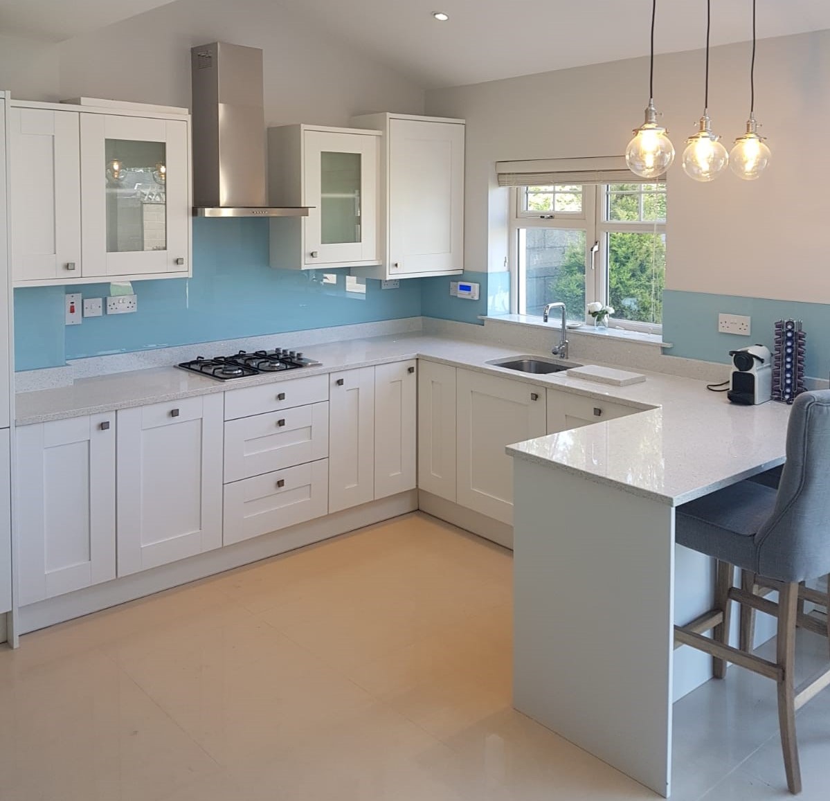 Pale blue Allspec glass splashback in a bright white kitchen